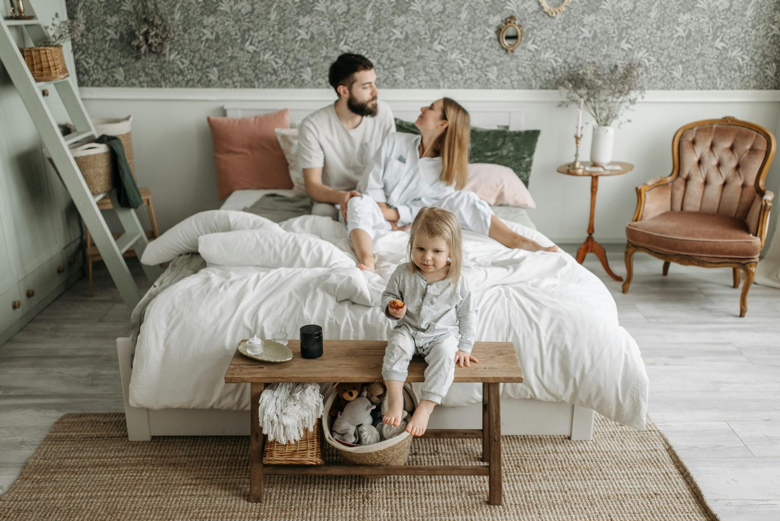 A young family enjoying a peaceful morning in their stylish bedroom setting.